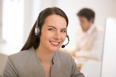 Beautiful Businesswoman in the office on the phone, headset