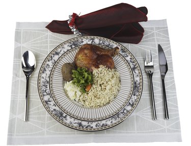 Place setting with meal of chicken and rice