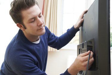 Television Engineer Installing New TV At Home