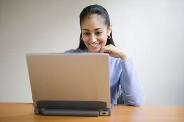 Young adult smiling with computer