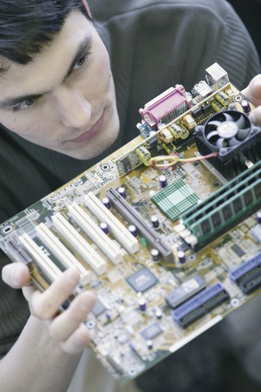 Computer technician with motherboard