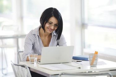 Portrait of a working businesswoman sitting at her desk