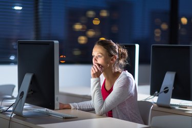 Pretty, young female college student using a desktop computer/pc