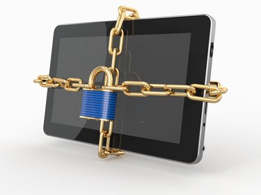 Tablet pc security. Chain with lock on computer.