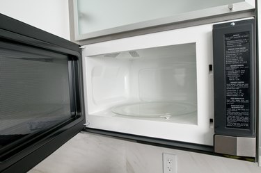 Open microwave oven in kitchen