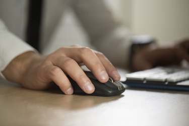 Hand of businessman use computer mouse and typing, partnership a