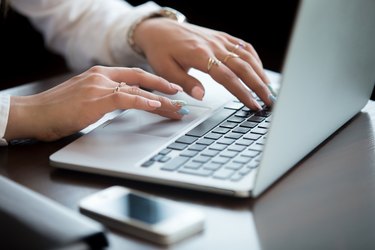 Hands on laptop keyboard