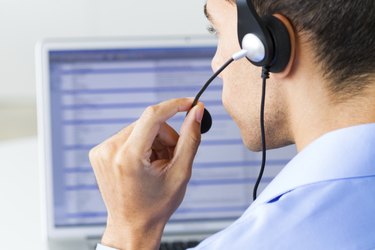 man wearing headset looking at monitor