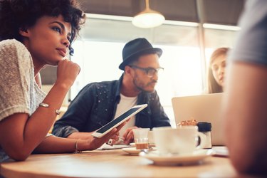 Young friends at a coffee shop with laptop