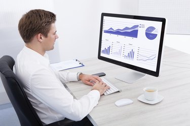 Young Businessman Using Computer At Desk