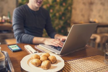 Man sitting in chinese restaurant and working on his laptop