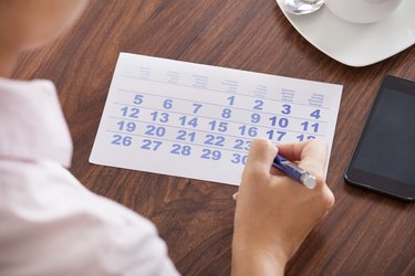 Businesswoman Marking In Calendar