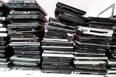 Stack of old, broken and obsolete laptop computer