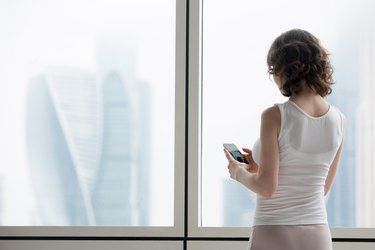 Young woman using smartphone indoors