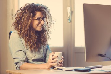 Young woman working at home or in a small office