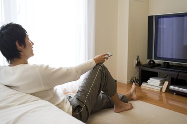 Man sitting on floor and watching TV