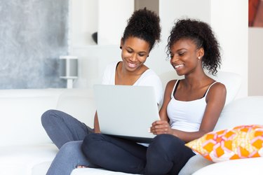 African American student girls using a laptop computer