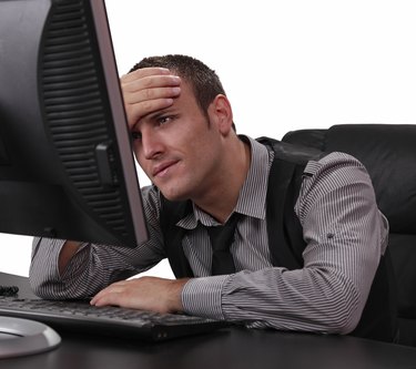 Unhappy Young Man in Front of the Computer