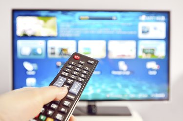 Smart tv and  hand pressing remote control