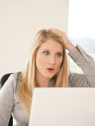 Shocked blond young woman in office