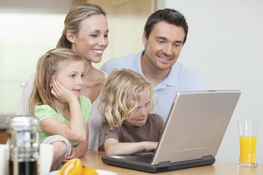 Family using their laptop in the kitchen