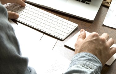 Male hands on keyboard and track pad