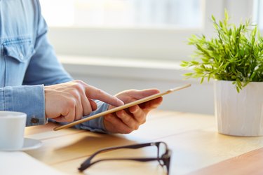 Man surfs the internet with the tablet