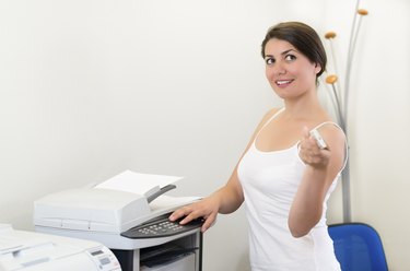Young business woman making copies