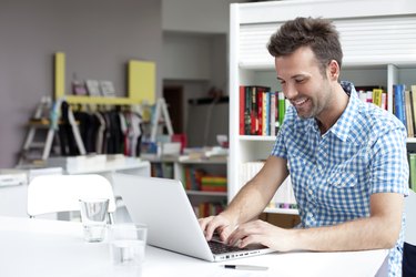 Student working on laptop in library