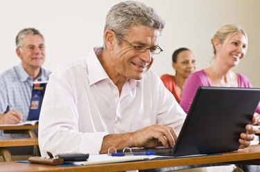 Man using laptop computer in classroom