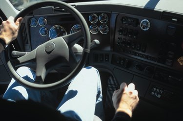 Interior view of man driving truck