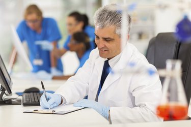 middle aged medical researcher working in lab
