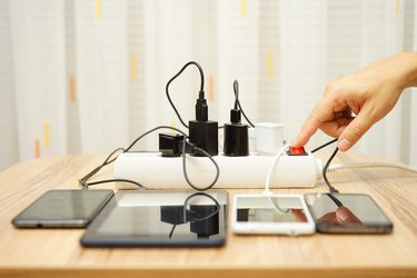 man is turning off  power adapters for mobile phones