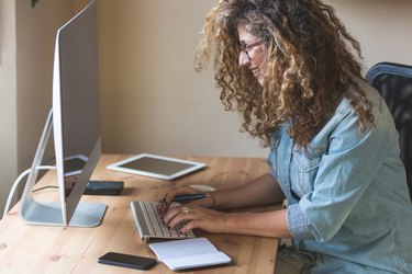 Young woman working at home or in a small office