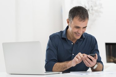 Happy  Mature Man Using Cellphone