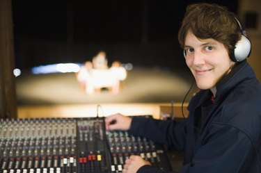 Portrait of a man at a sound mixer in a recording studio
