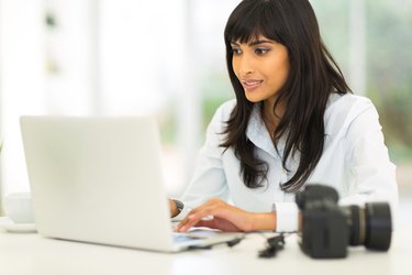 female photographer working on computer