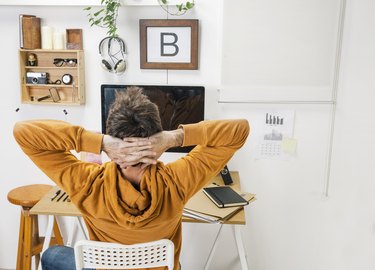 Modern creative man relaxing on workspace.