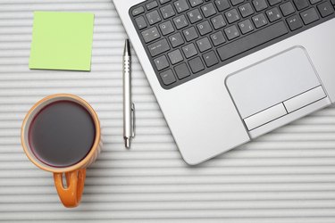 laptop computer on desk with cup of tea