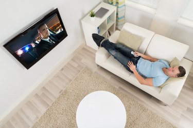 Man Watching Movie On Television In Living Room