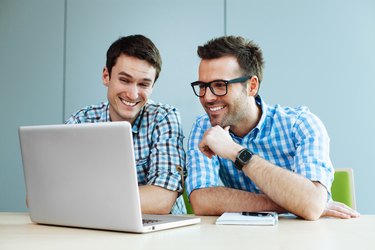 Students forking on laptop