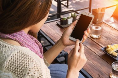 Woman using smartphone in the cafe.