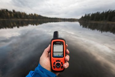 Photo of Garmin's inReach global satellite communicator handheld being used while on a river.
