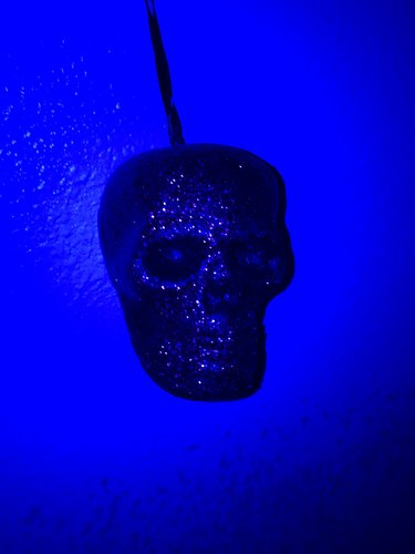 Toy skull under black light