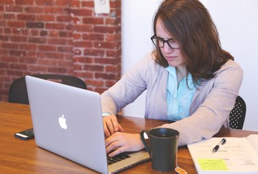 Woman working on Apple laptop