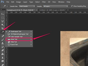 Selecting the Ruler tool in Photoshop.