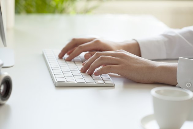 woman hands typing on computer keyboard