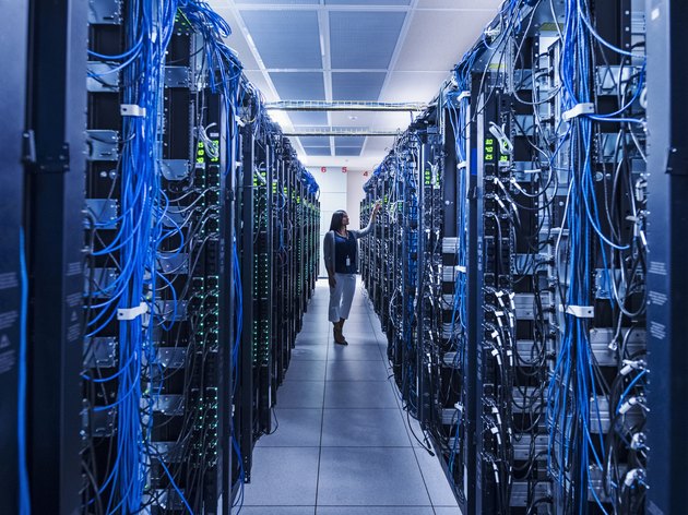 Woman standing in aisle of server room