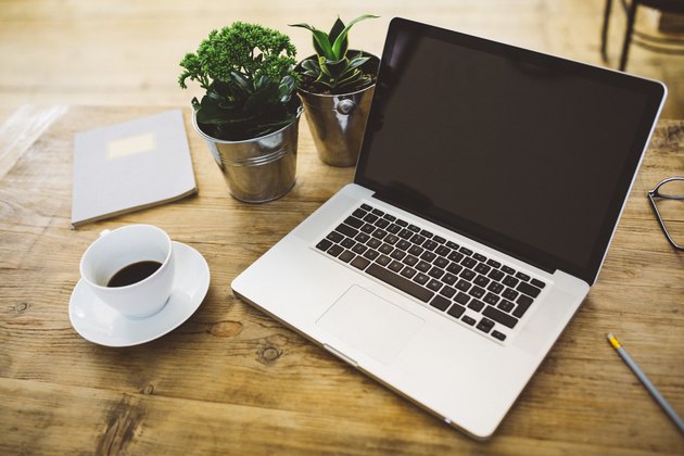 Laptop and a cup of coffee on a table