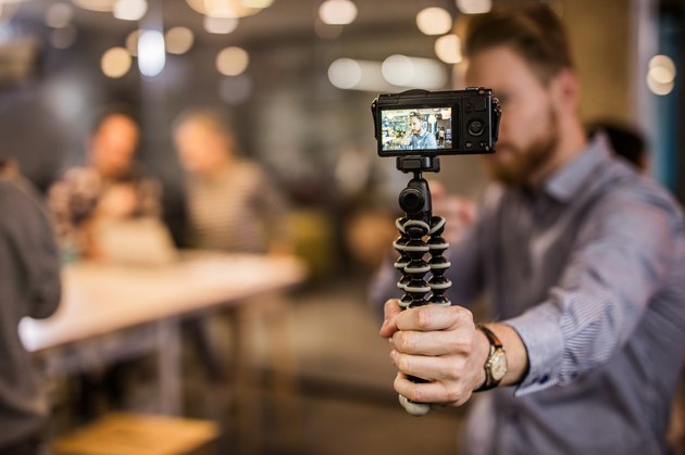 Close up of redhead man making reportage by vlogging.